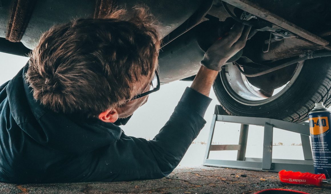 man fixing vehicle engine