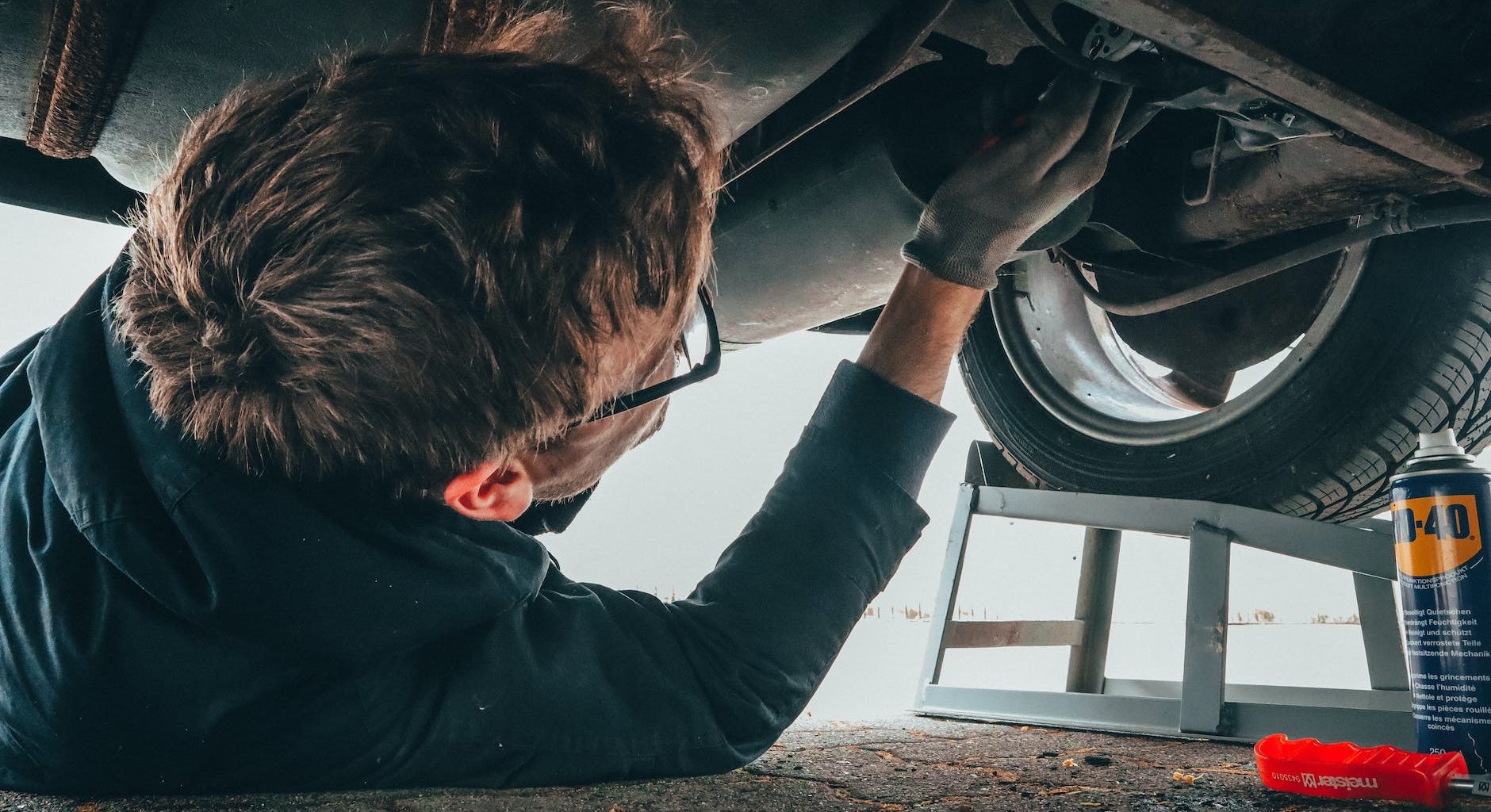 man fixing vehicle engine