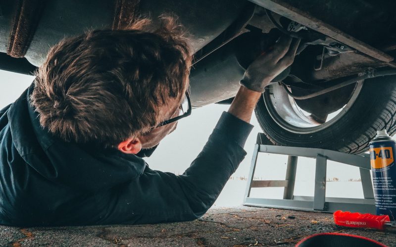 man fixing vehicle engine