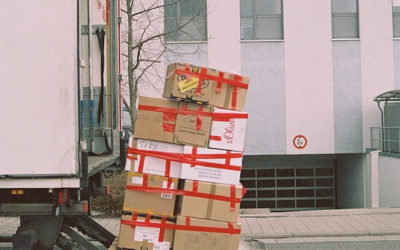 brown cardboard boxes on gray asphalt road