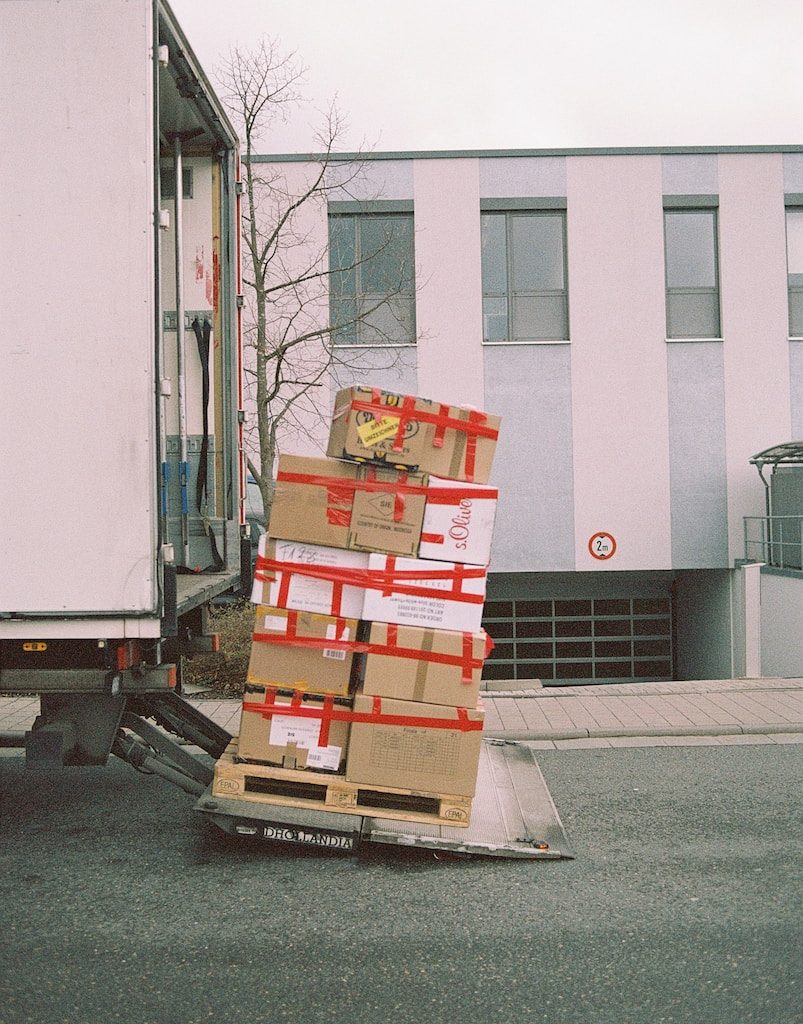 brown cardboard boxes on gray asphalt road