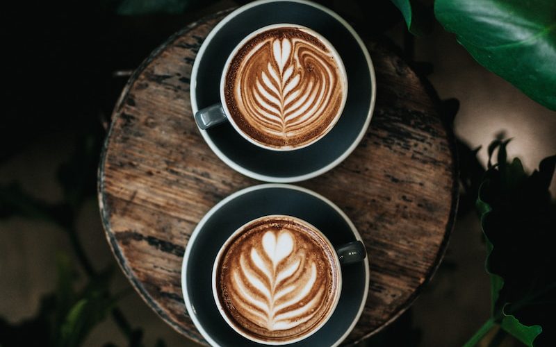 high angle photo of two green mugs filled with coffee