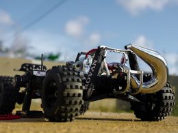 a toy truck with four wheels on a dirt road