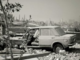 a black and white photo of a car and a truck