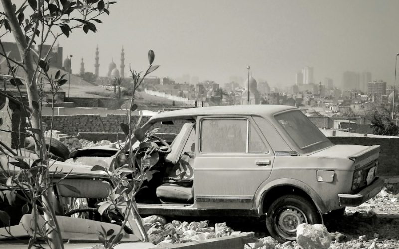 a black and white photo of a car and a truck