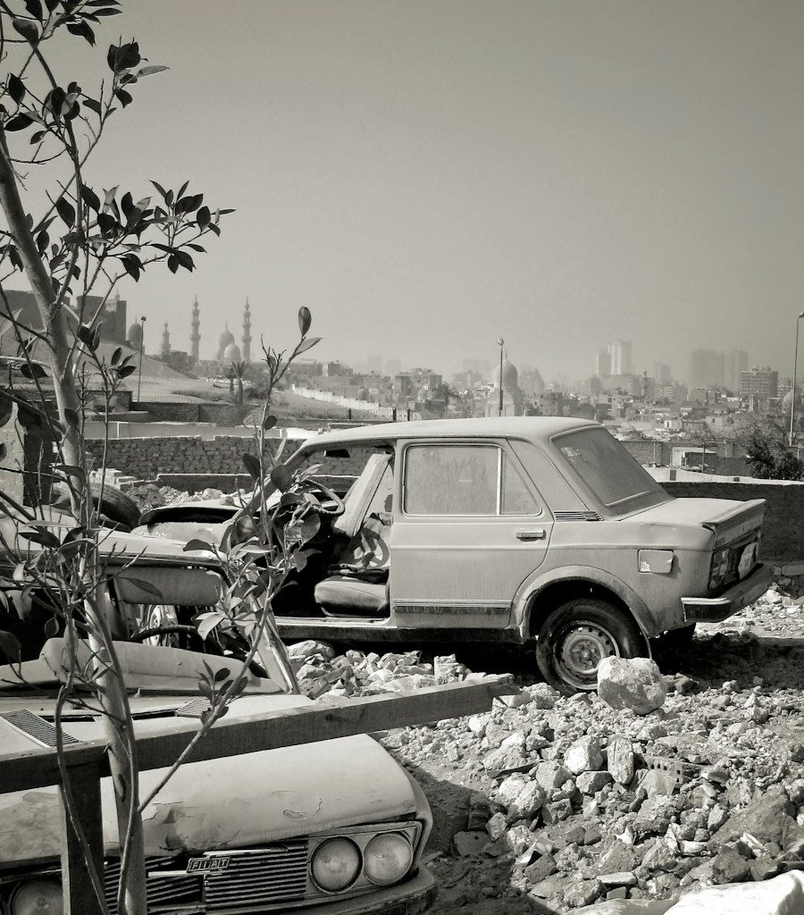 a black and white photo of a car and a truck