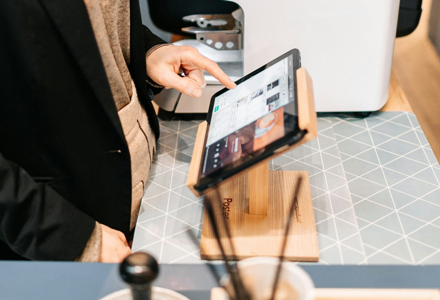 person in black blazer holding black ipad