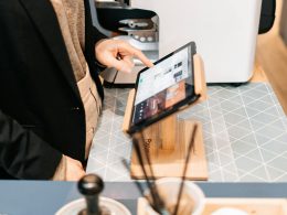 person in black blazer holding black ipad