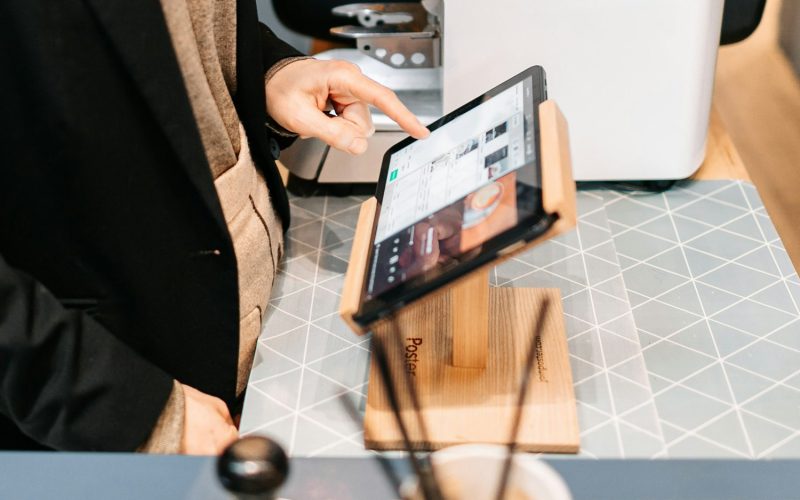 person in black blazer holding black ipad