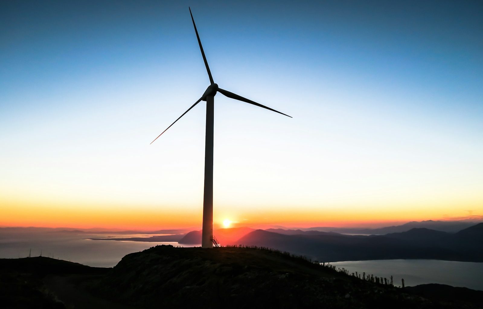 silhouette of wind mill during golden hour