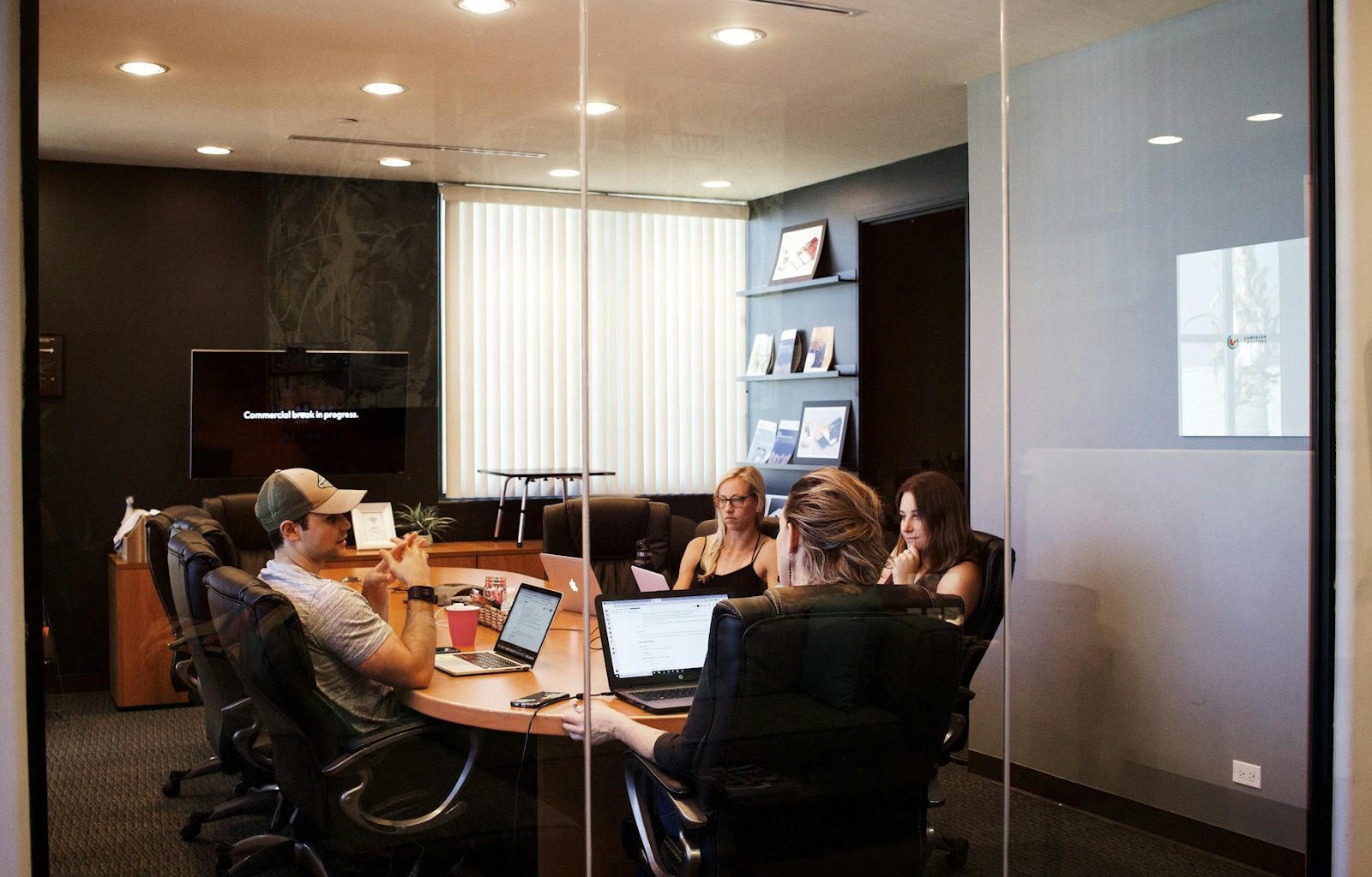 people sitting near table with laptop computer