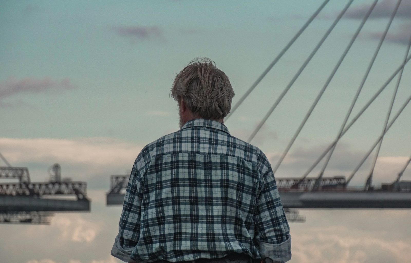 a man standing in front of a body of water