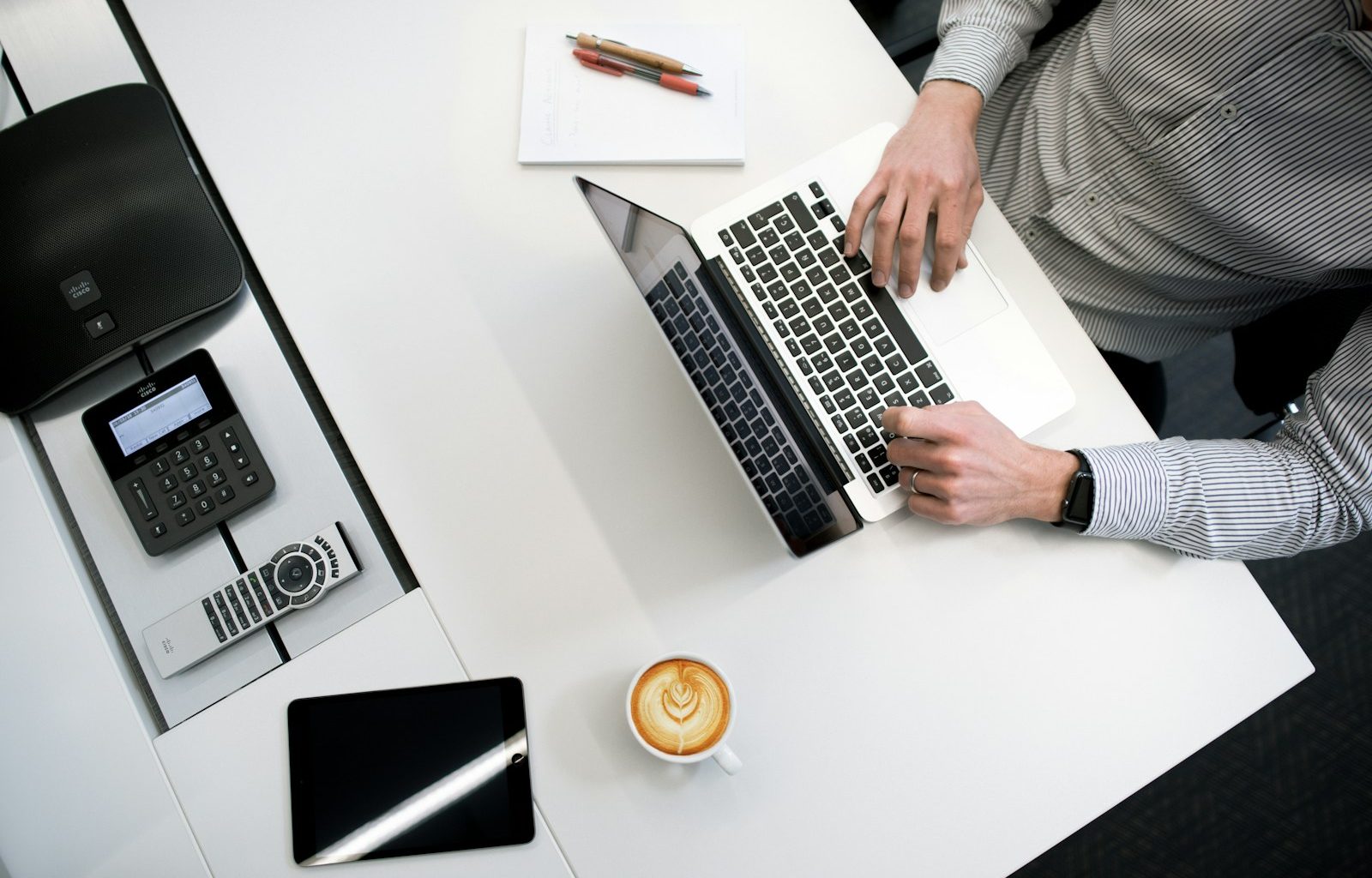 person using laptop on white wooden table