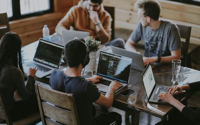 group of people using laptop computer