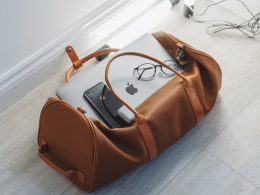 silver MacBook in duffel bag