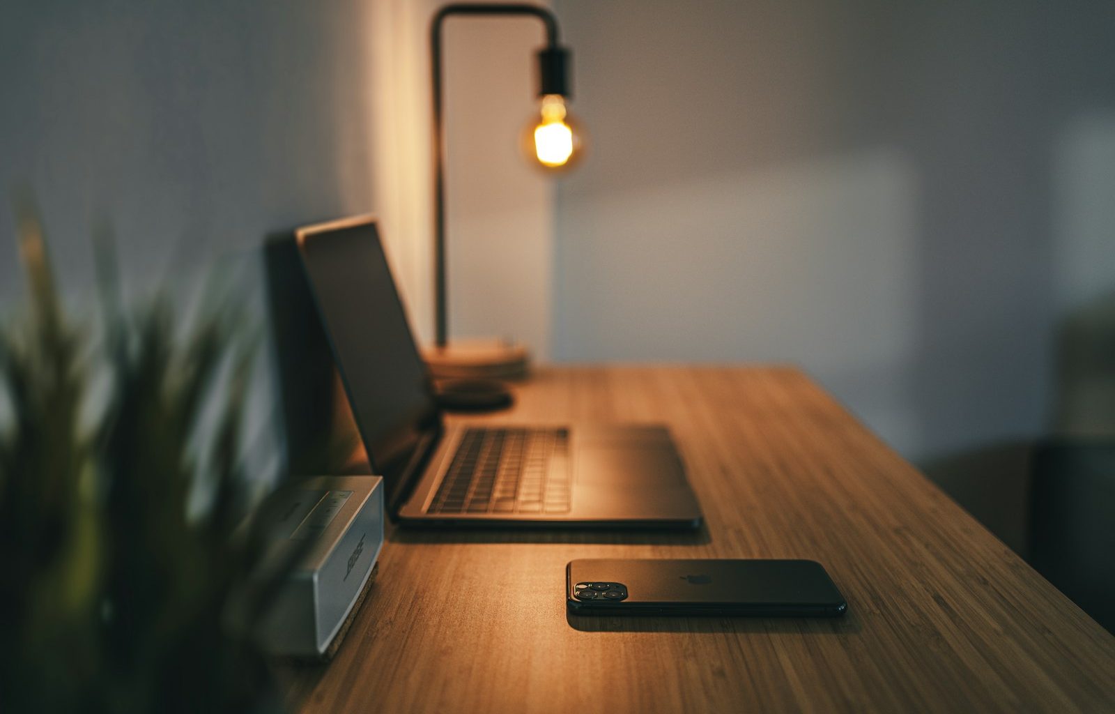 black laptop computer on brown wooden table