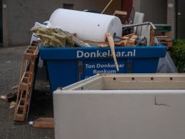 A pile of junk sitting outside of a building