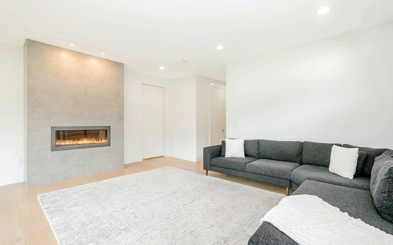 black couch near black fireplace