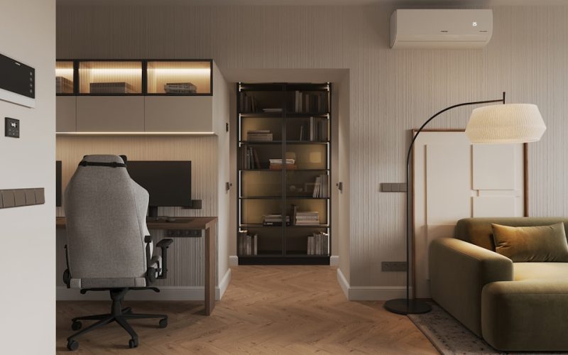 A living room with a couch a chair and a desk
