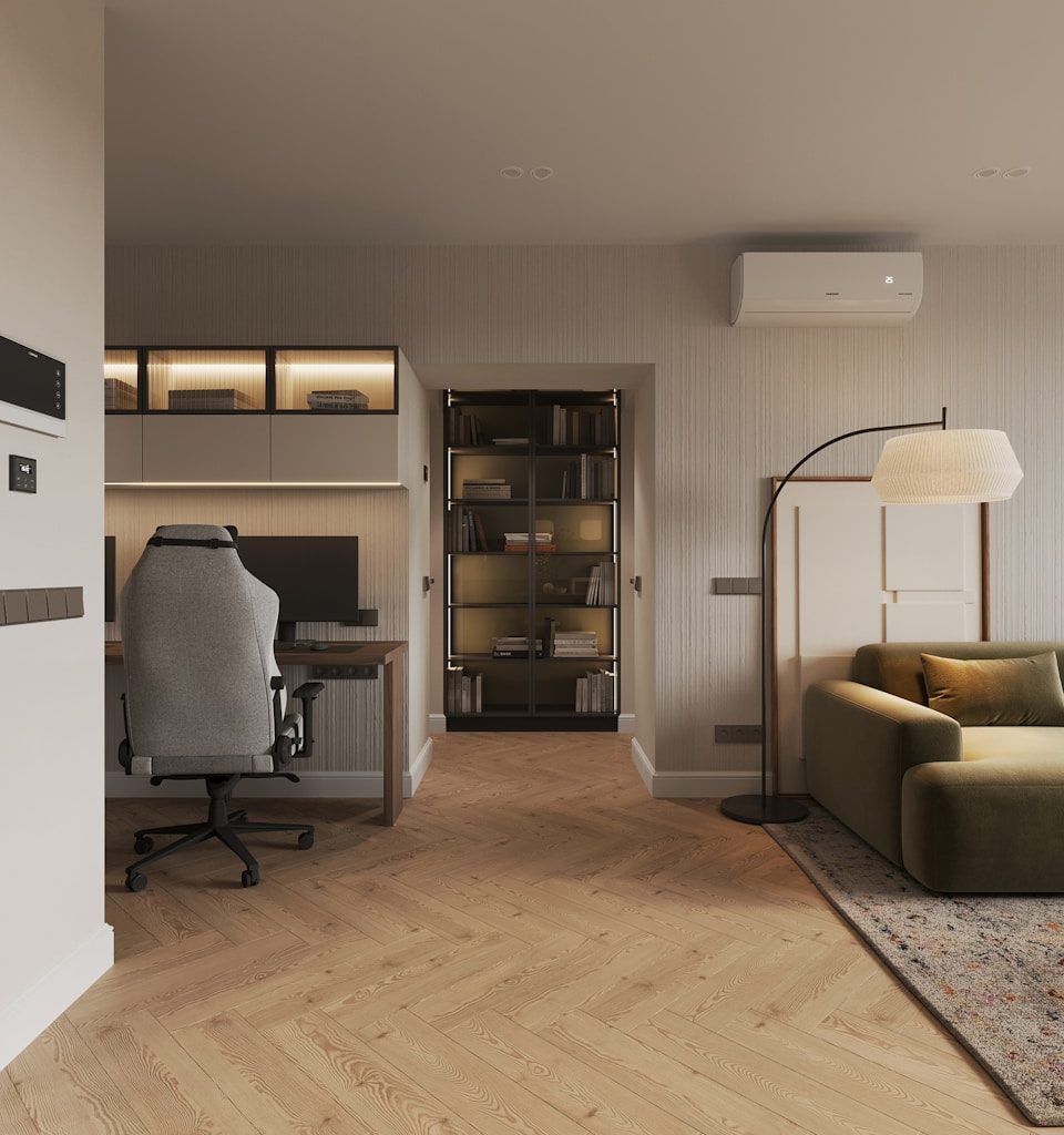 A living room with a couch a chair and a desk
