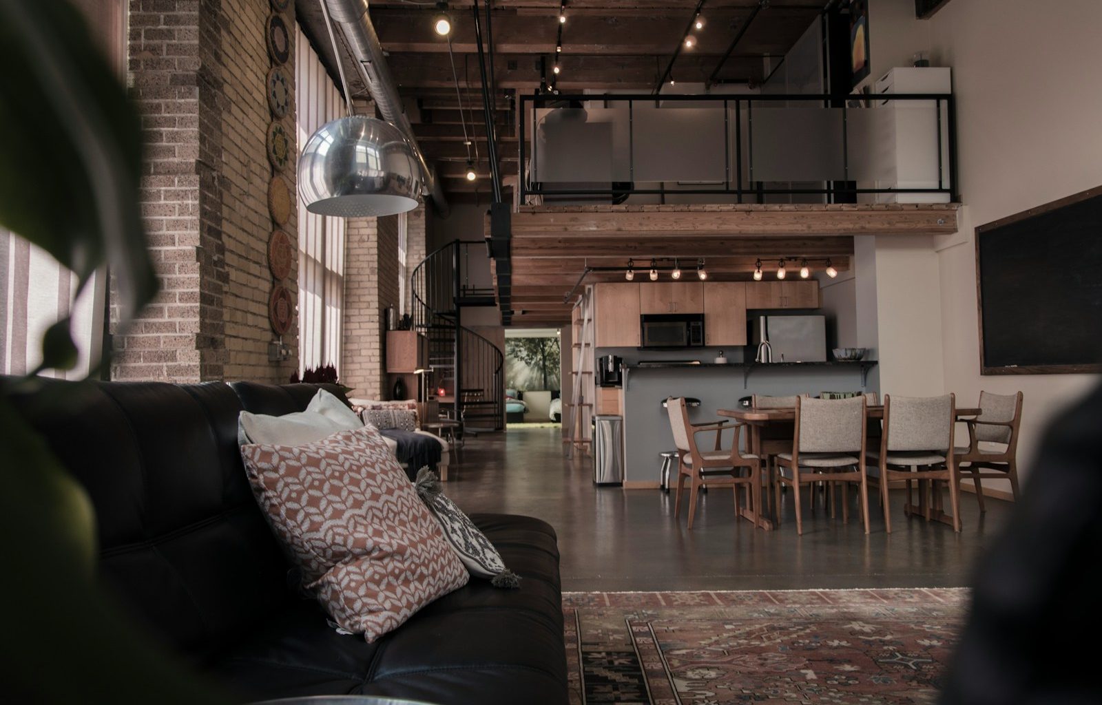 black leather couch with gray throw pillwo