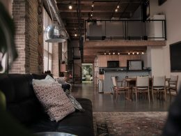 black leather couch with gray throw pillwo