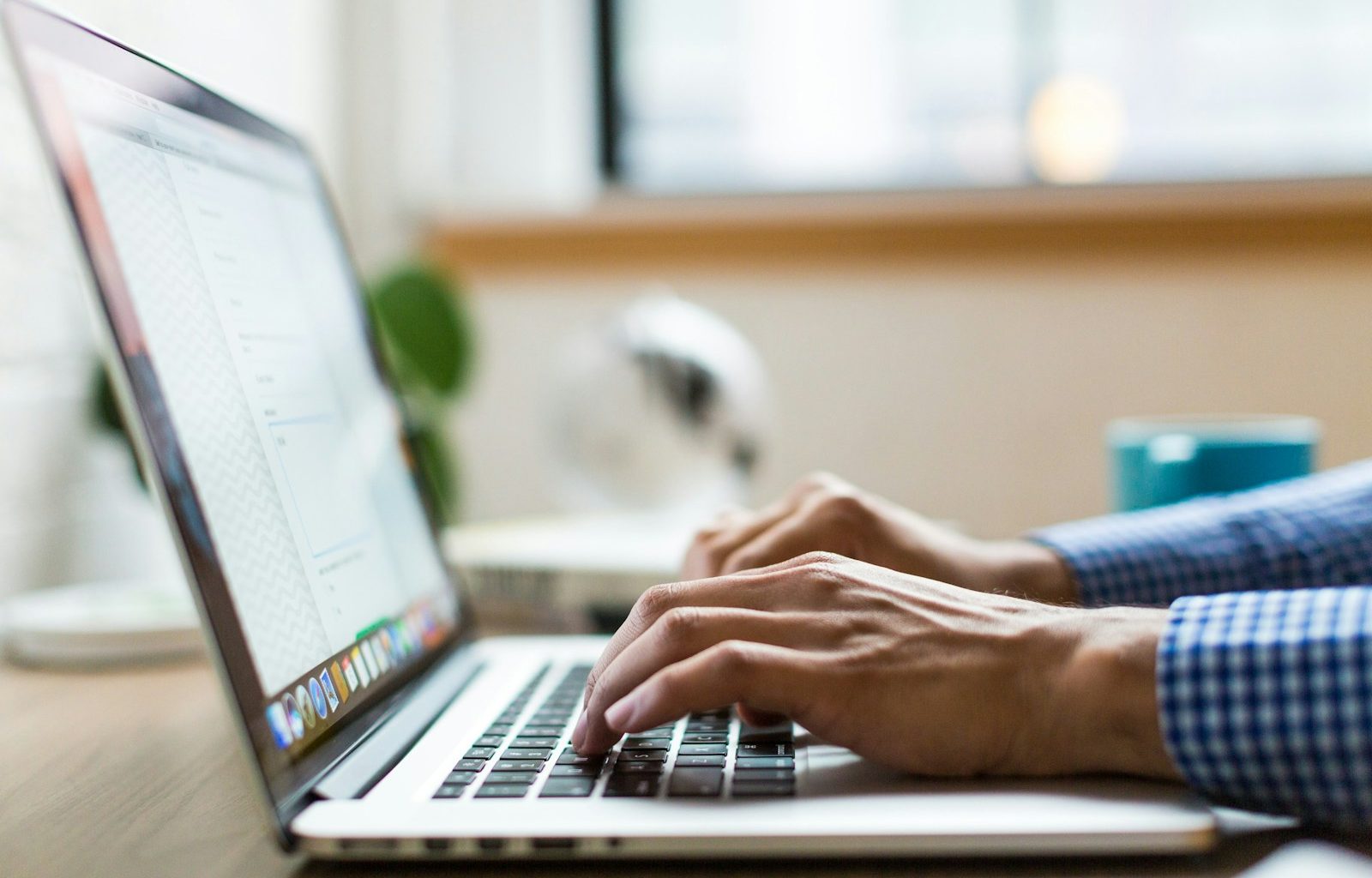 person typing on silver MacBook
