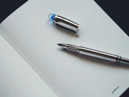 silver and blue click pen
