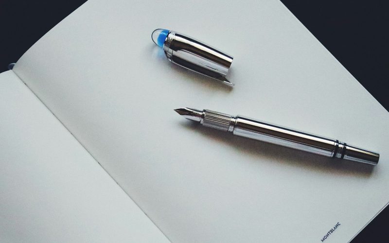 silver and blue click pen