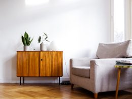 brown wooden table beside gray couch