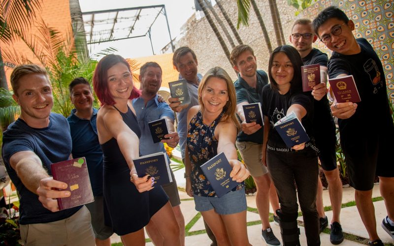 group of people standing near green plant