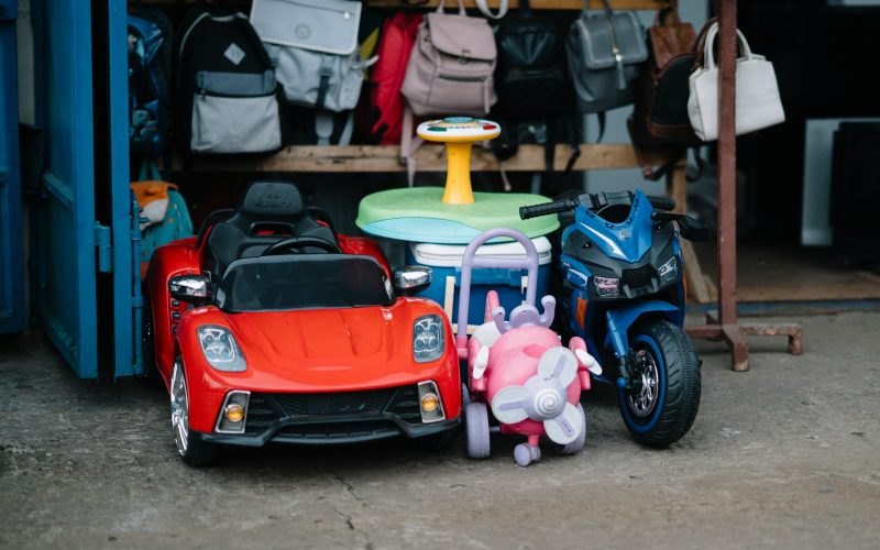 Children's ride-on toys and backpacks displayed bags