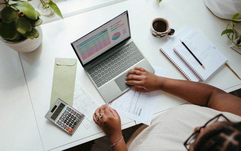 a person sitting at a table with a laptop